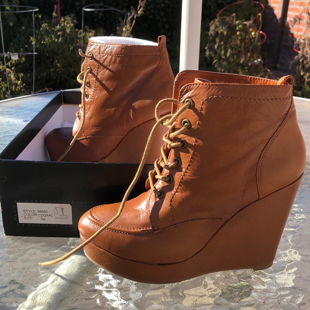 Size 7M new in box vegan leather cognac brown wedge booties. Urban outfitters